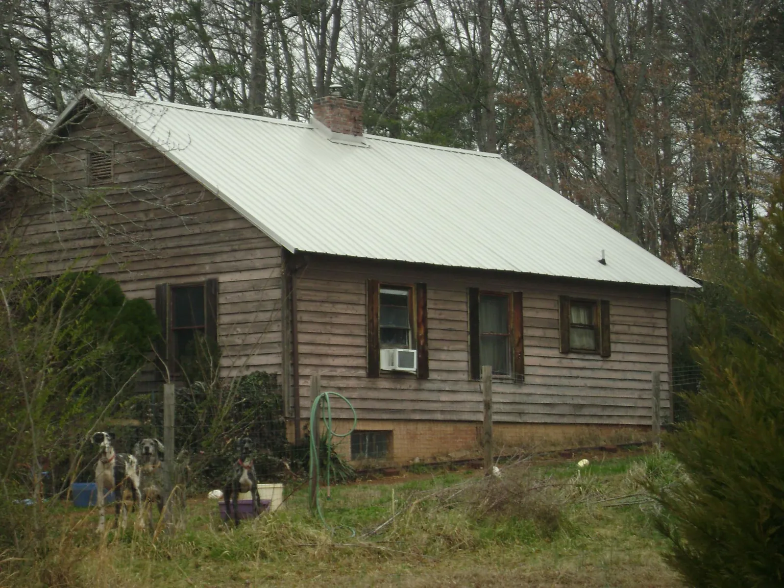 White metal roof on an old wood sided farmhouse, from a Metal Roof Installation job in Colville
